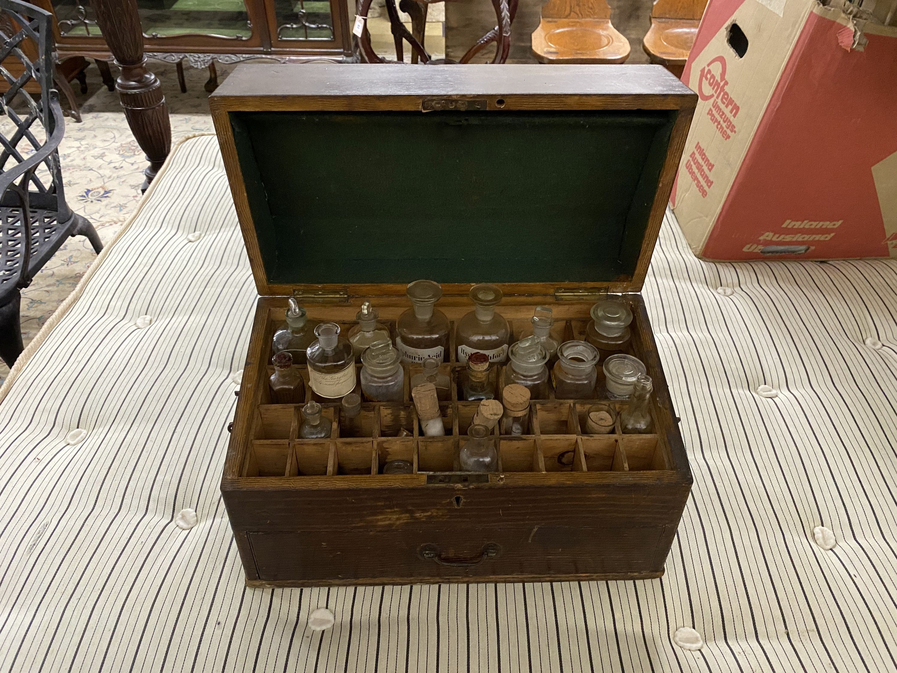 A Victorian apothecary chest with painted simulated grain fitted with assorted glass bottles and phials, width 46cm, depth 25cm, height 30cm
